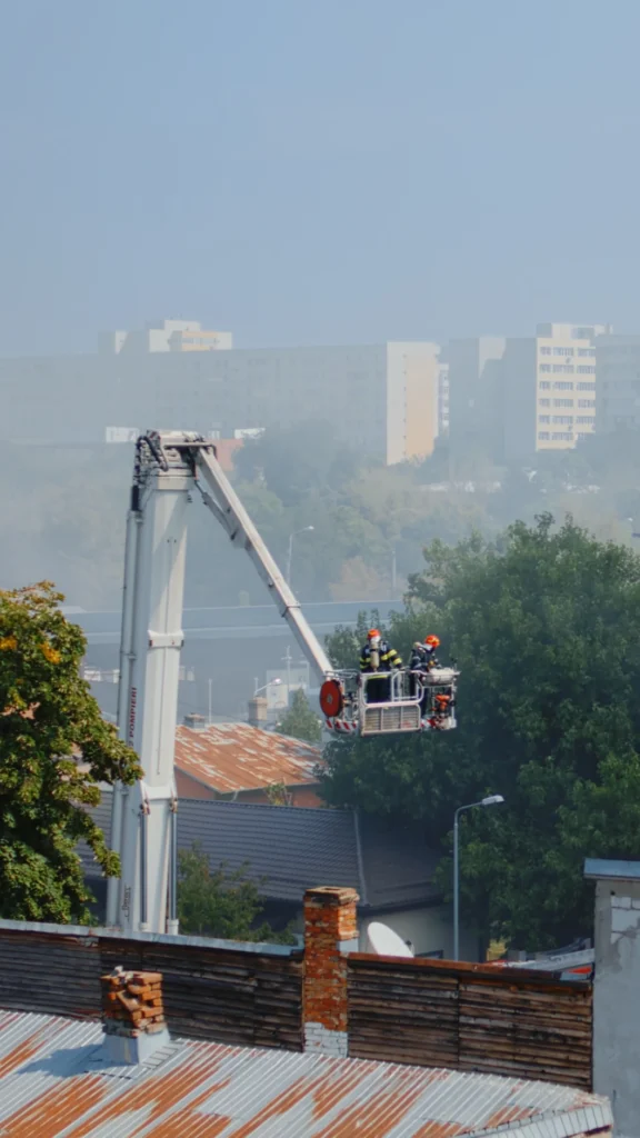 men from fire department using firetruck help firefighters building firemen saving house fire with equipment water extinguish flames fumes city neighbourhood resized
