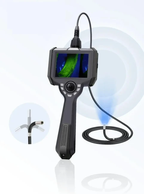 All-in-one handheld joystick-controlled UV borescope system, flexible articulating probe with built-in ultraviolet LED, screen displaying fluorescent green defect imaging of metal components
