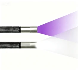 Side-by-side slim stainless steel flexible borescope probes; top unit emits purple UV ultraviolet light for fluorescent penetrant testing, bottom unit outputs standard white light for general visual inspection
