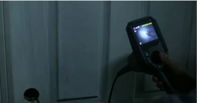 Operator using infrared industrial borescope for dark space internal inspection
