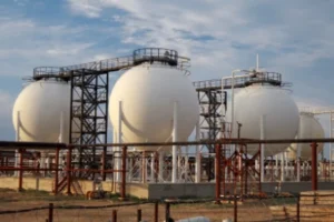 Large white spherical storage tanks in petrochemical plant, industrial pipeline facility