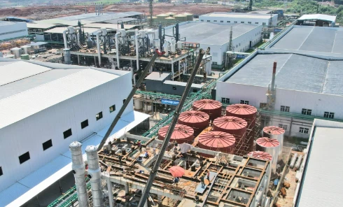 Aerial view of large petrochemical factory plant under construction with storage tanks